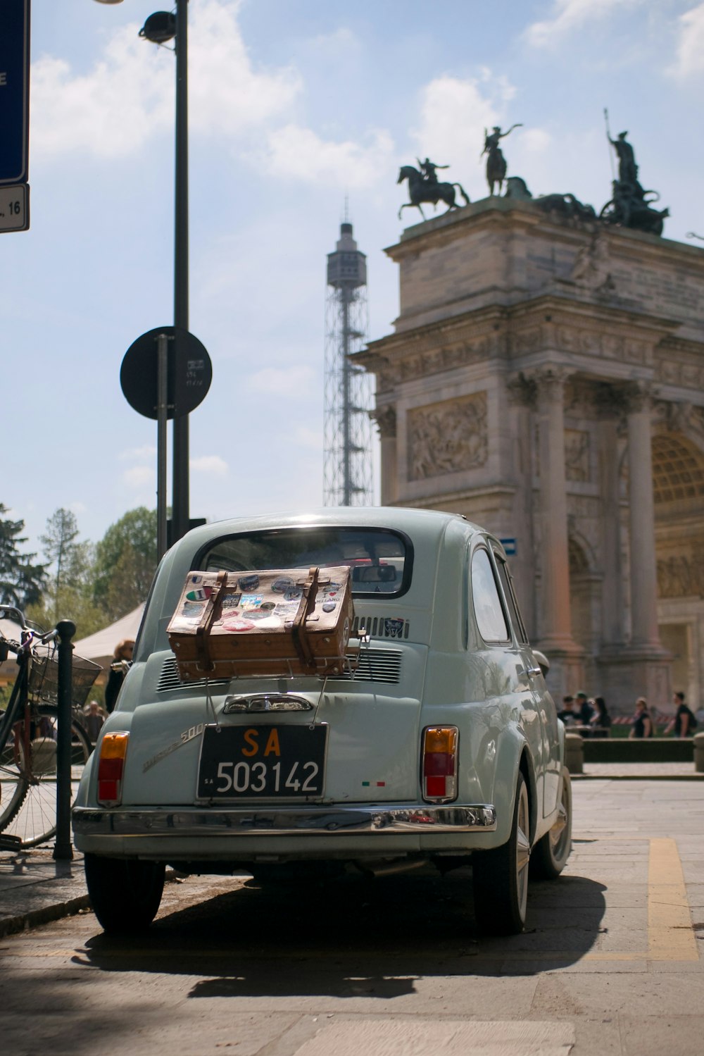 an old car is parked on the side of the road