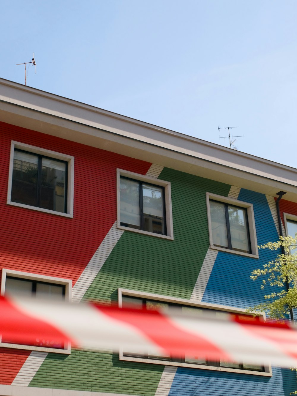 a multi - colored building with a red, white, green, blue, and