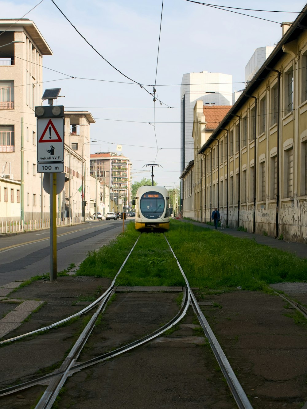 a train traveling down train tracks next to a building
