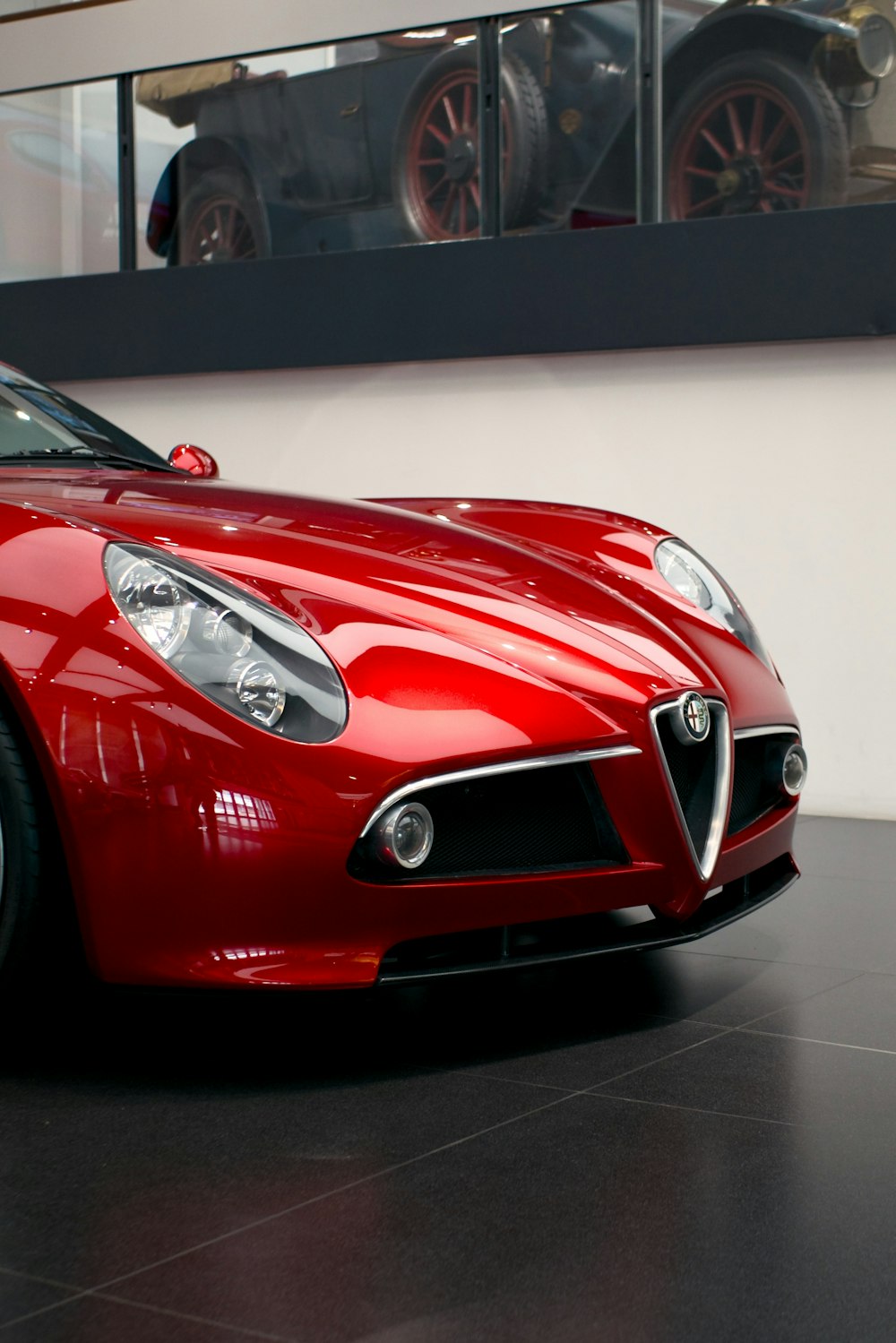 a red sports car parked in a showroom