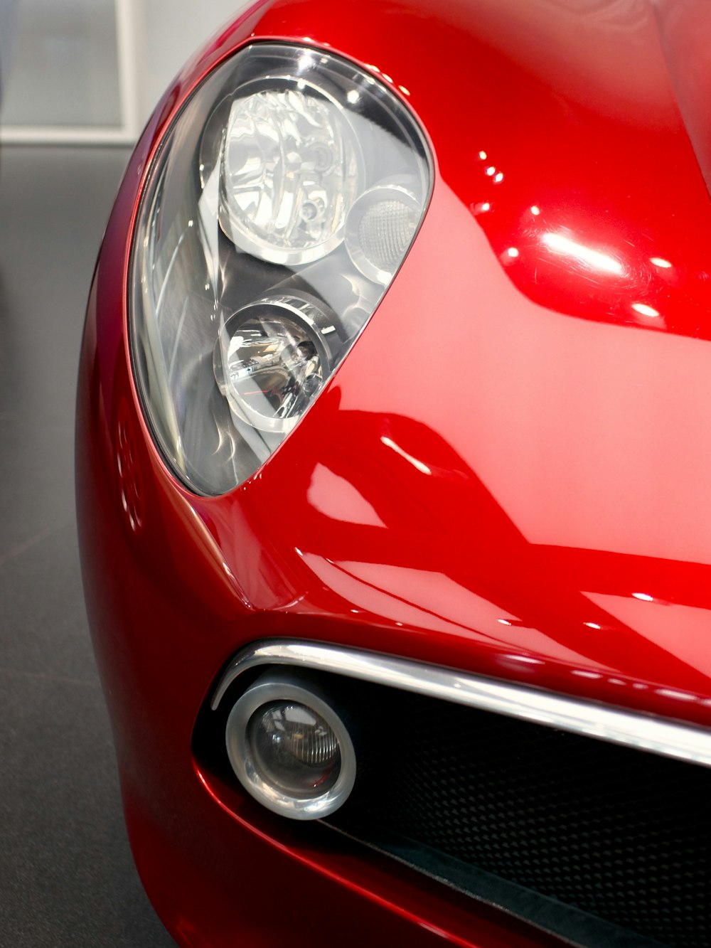 a close up of the front of a red sports car