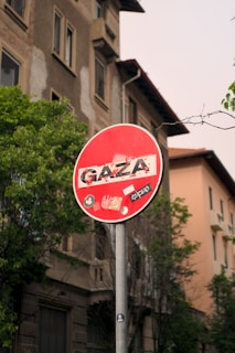 a red street sign sitting on the side of a road