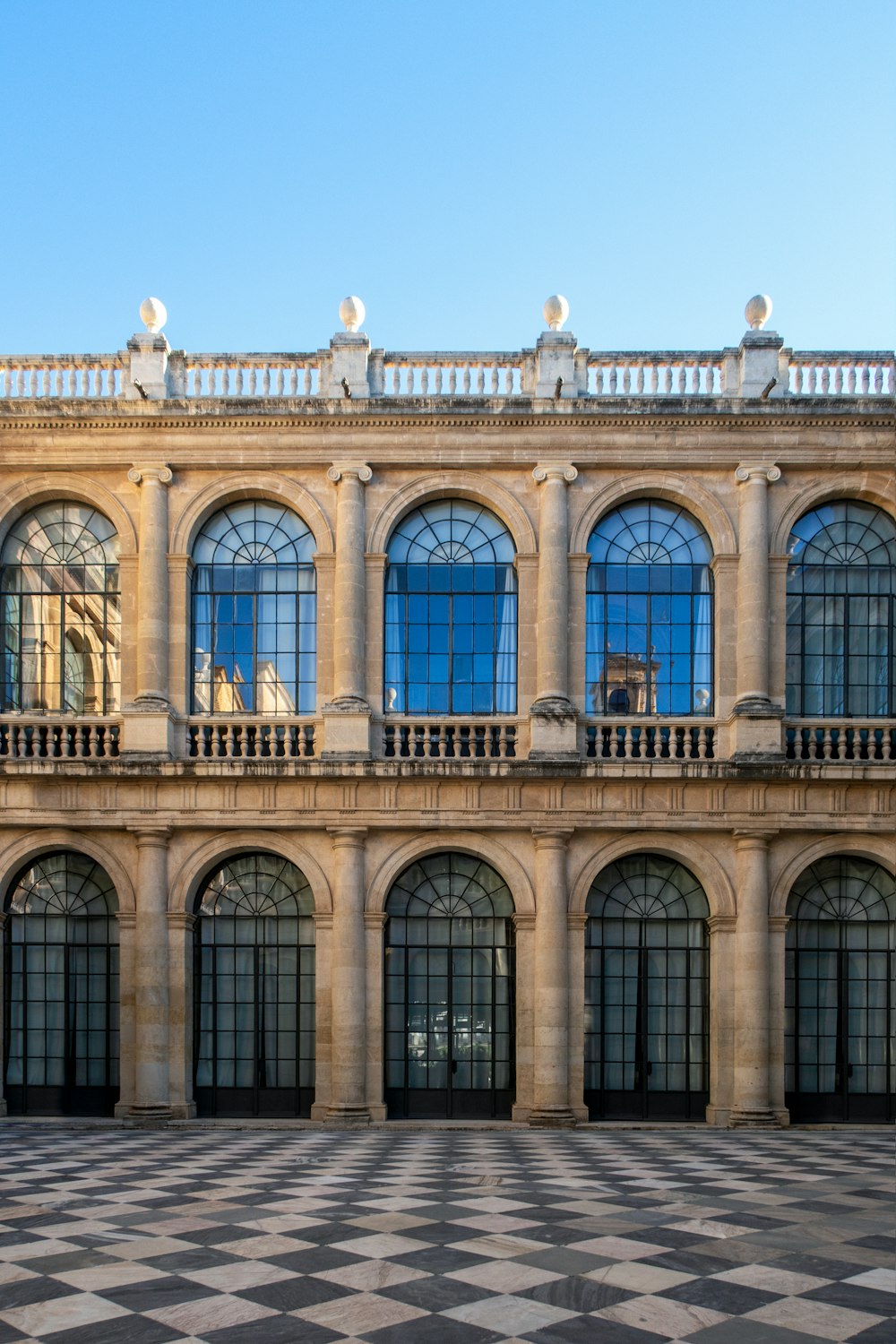 a large building with a checkered floor in front of it