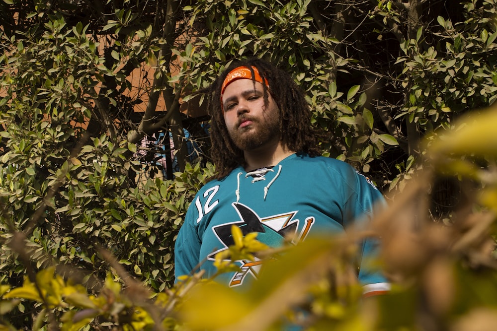 a man wearing a blue shirt and orange headband