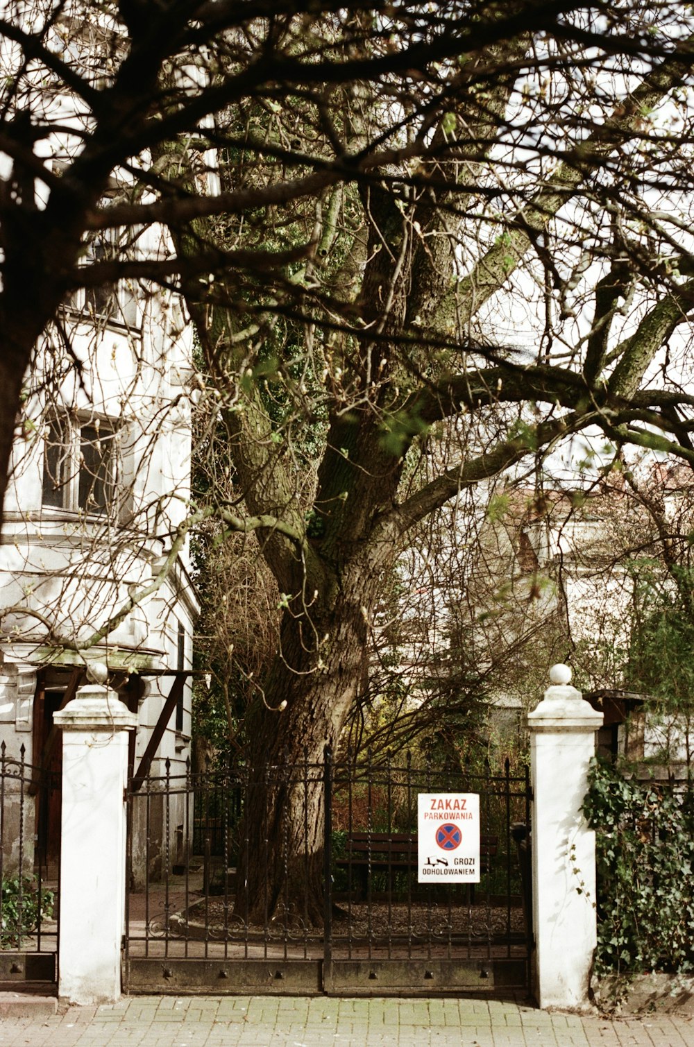 a gate with a sign on it in front of a building