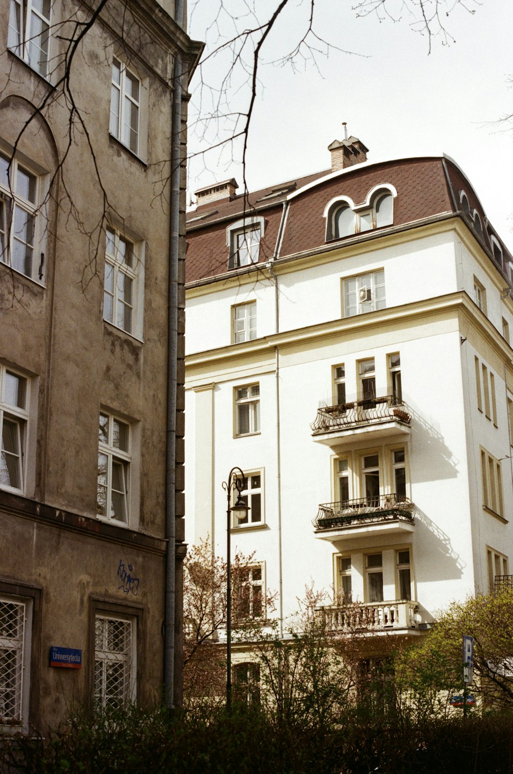 a tall white building sitting next to a tall building