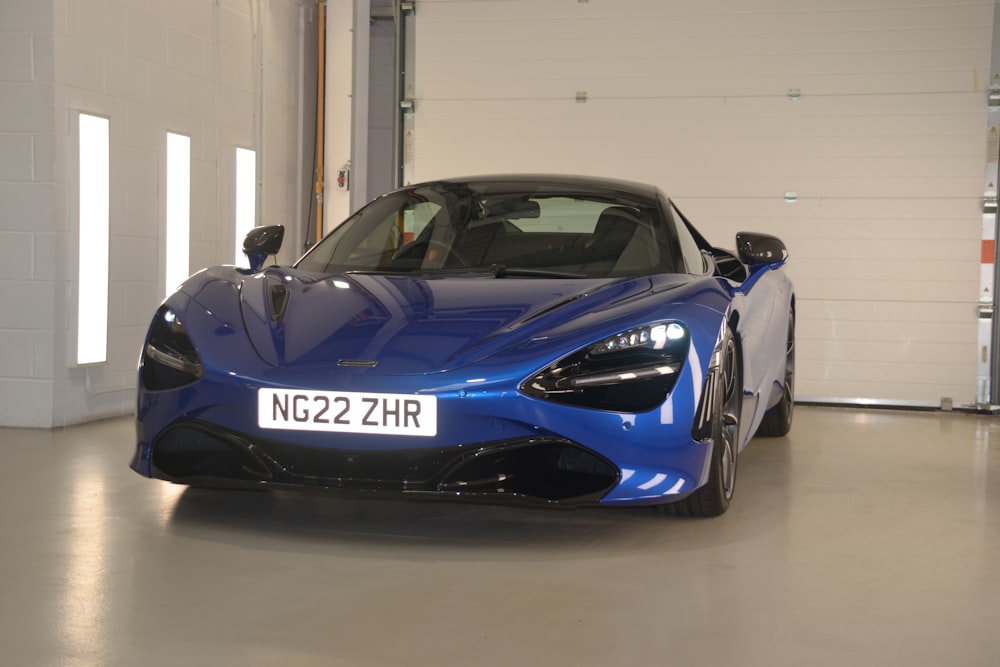 a blue sports car parked in a garage