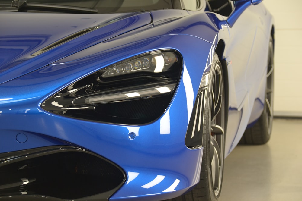 a blue sports car parked in a garage