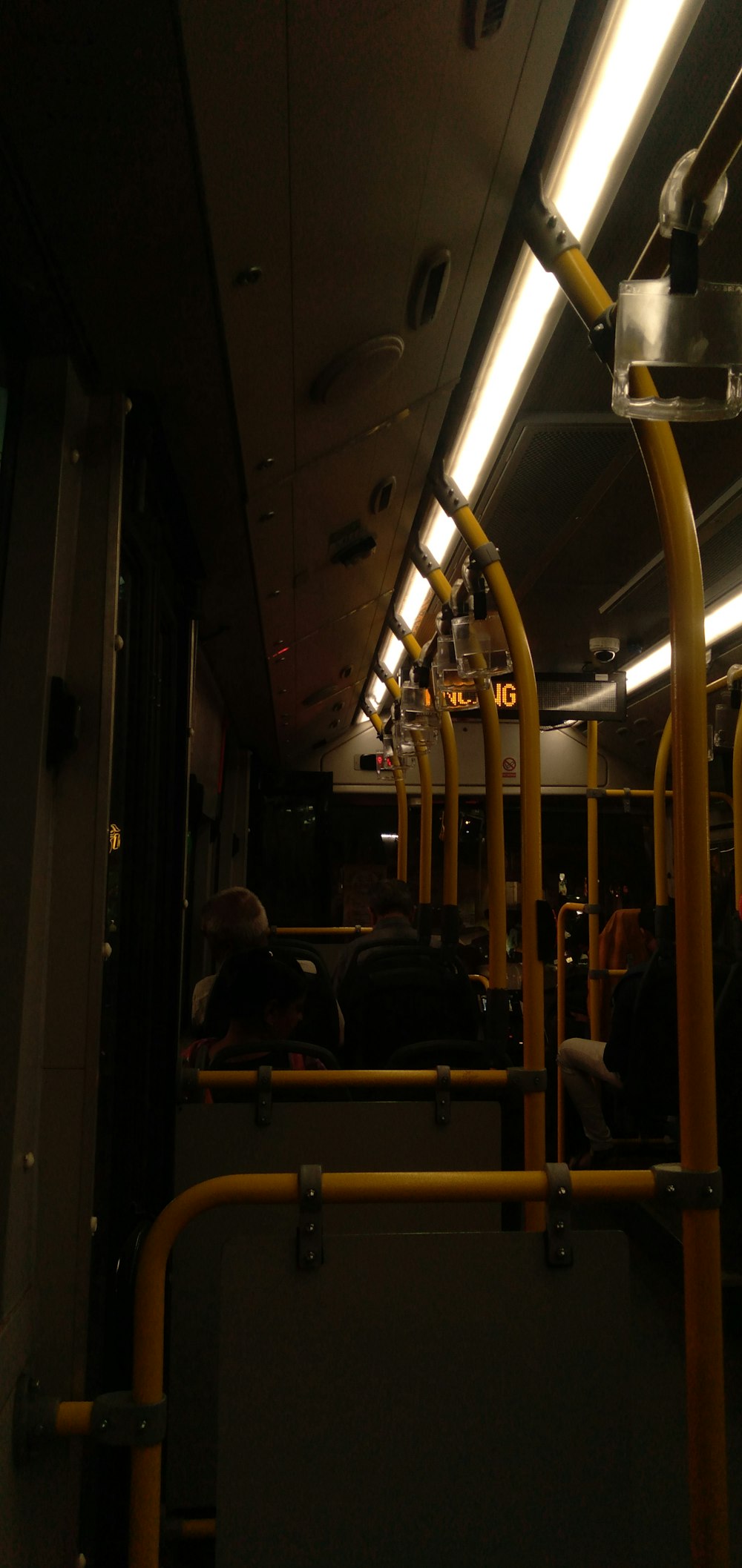 the inside of a public transit bus at night