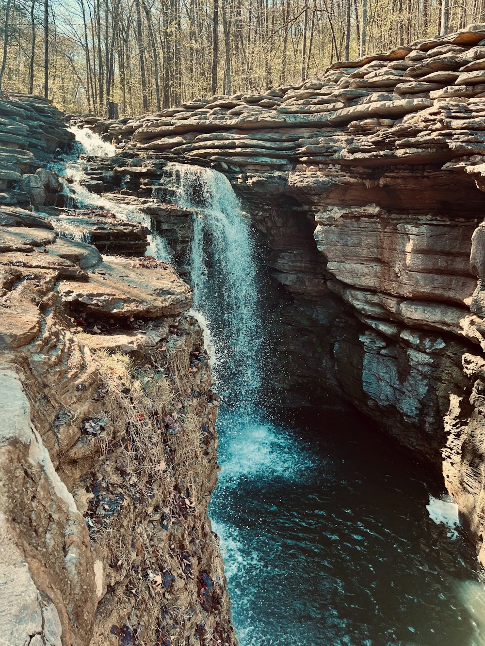 a small waterfall in the middle of a canyon