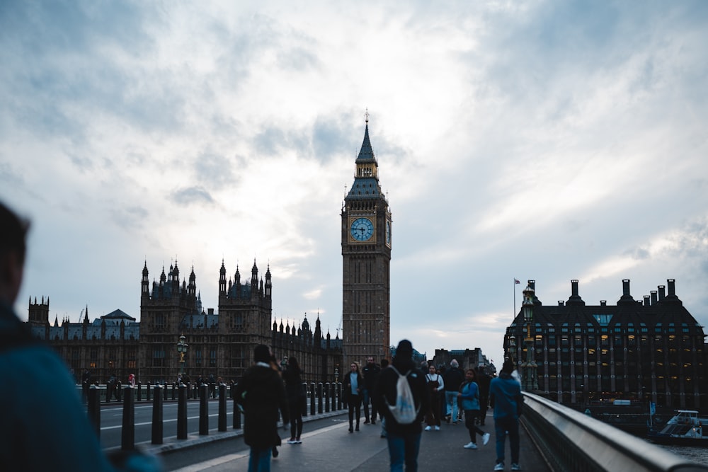 a group of people walking across a bridge