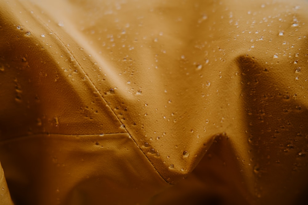 a yellow cloth with water drops on it