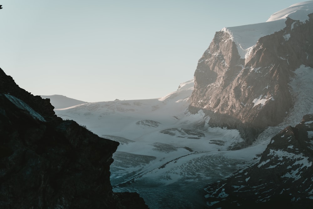 a person standing on top of a snow covered mountain