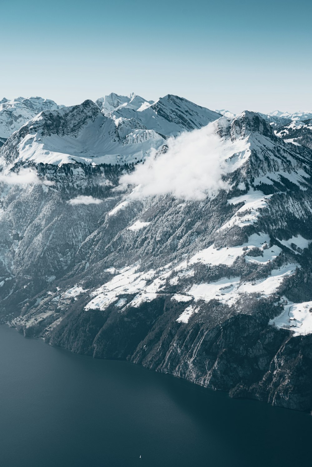 an aerial view of a snow covered mountain range