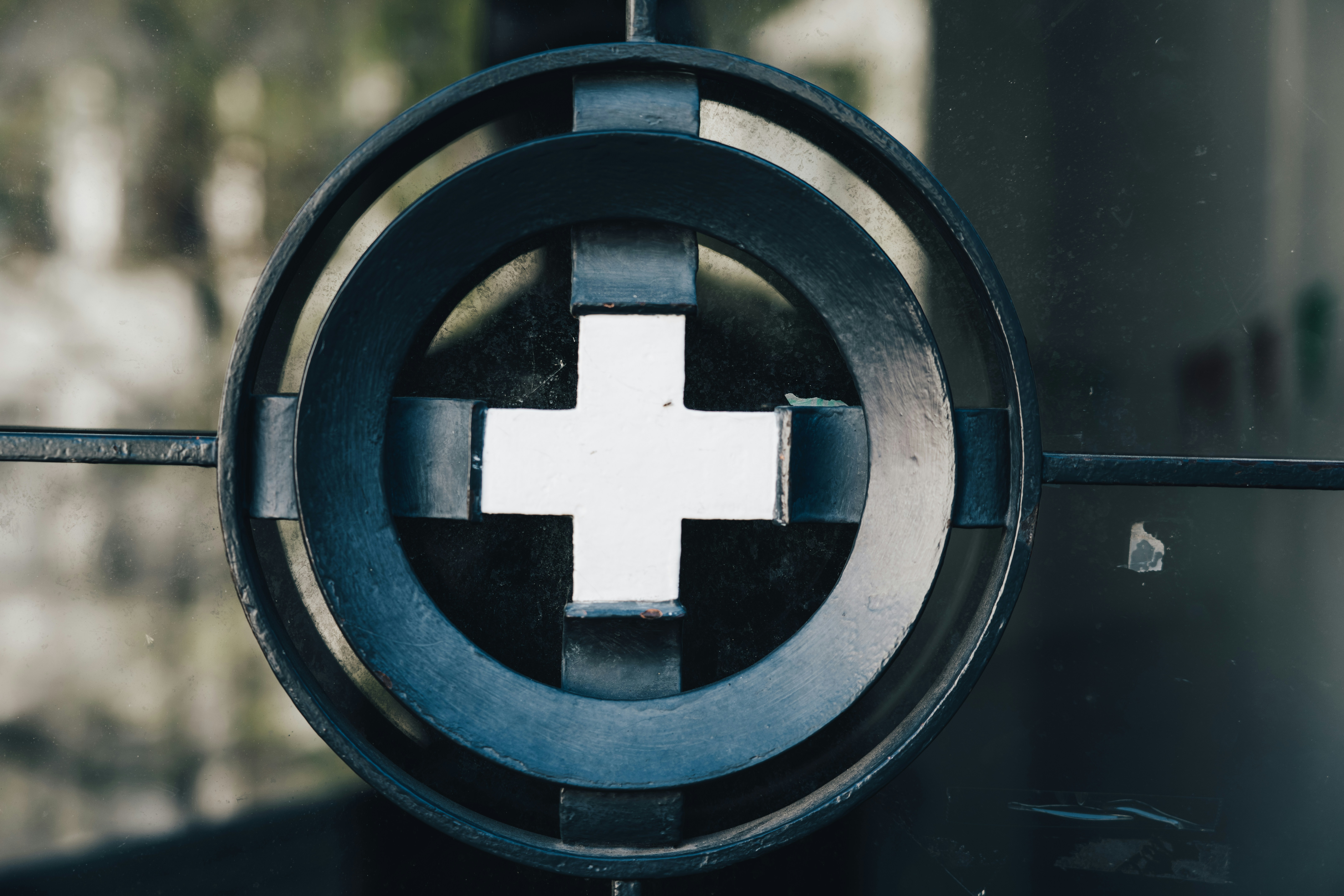 A close up of a metal object with a cross on it