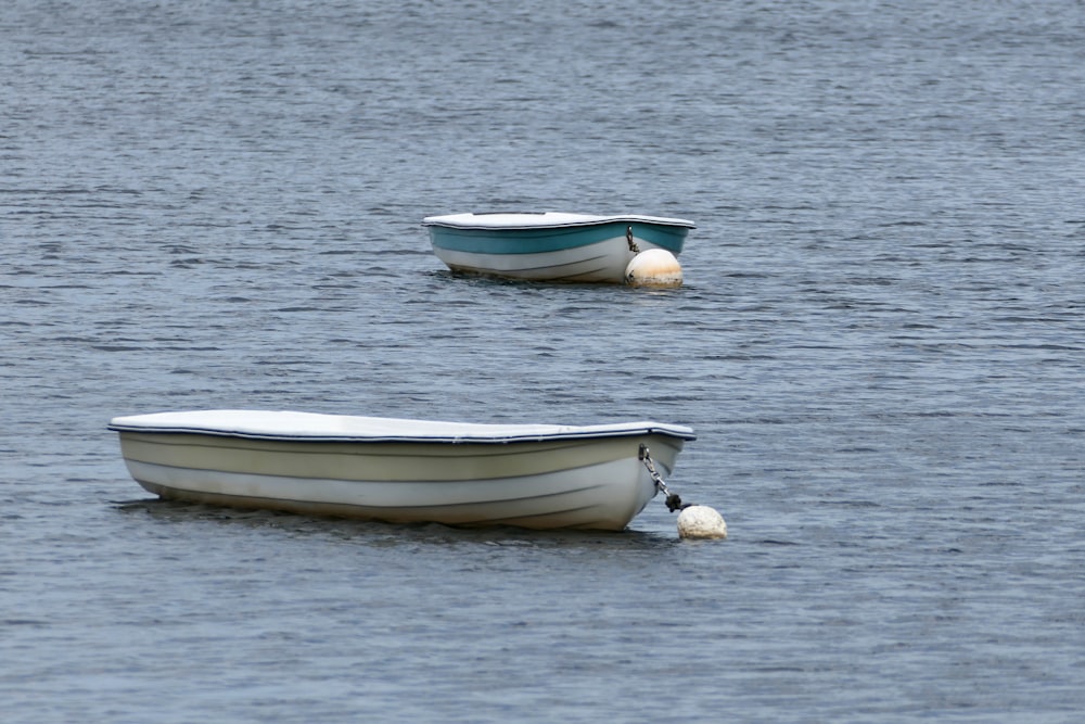 a couple of boats floating on top of a lake