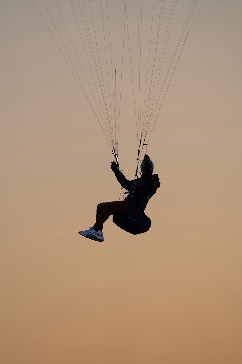 a person in the air with a parachute