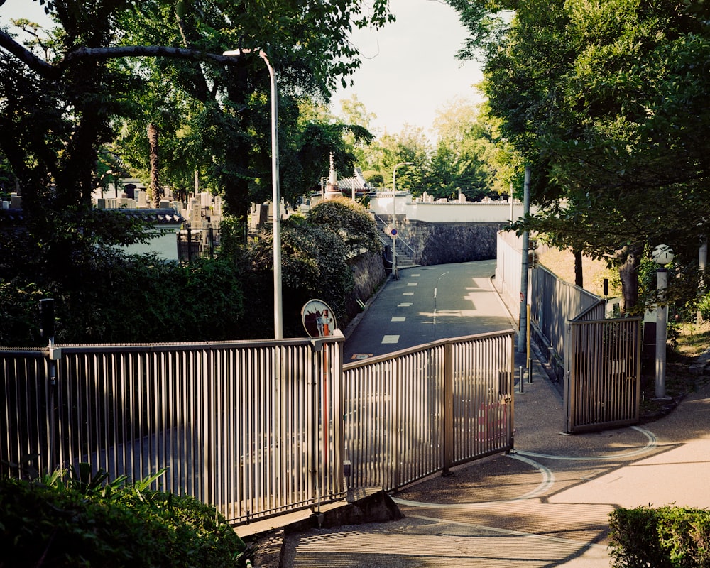 a street with a fence and a street sign