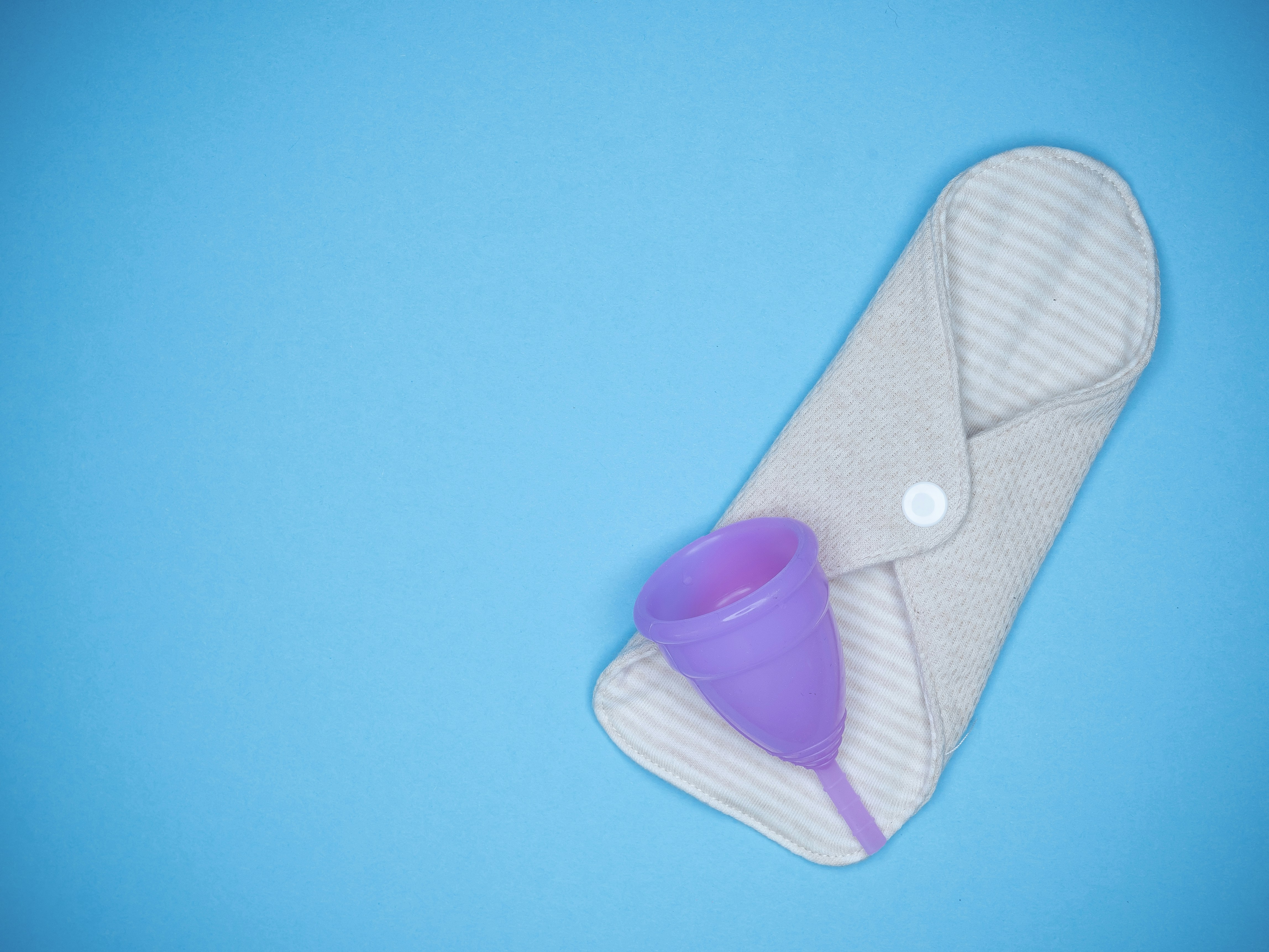 a pair of slippers and a cup on a blue background