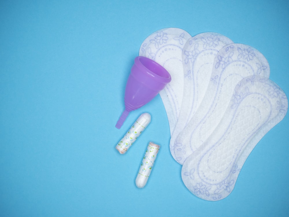 a blue background with a purple and white object and a purple and white object