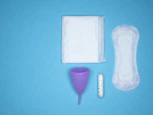 a blue table with a toothbrush, a tube of toothpaste and a