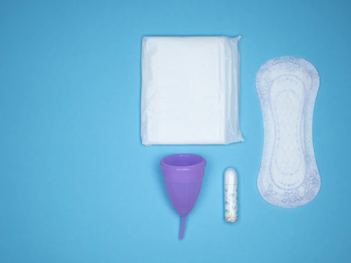 a blue table with a toothbrush, a tube of toothpaste and a