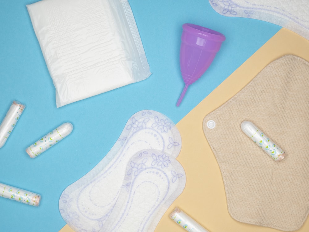 an assortment of baby products laid out on a blue background