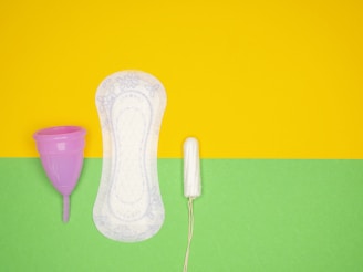 a hairdryer and a pair of shoes on a green and yellow background