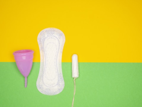a hairdryer and a pair of shoes on a green and yellow background