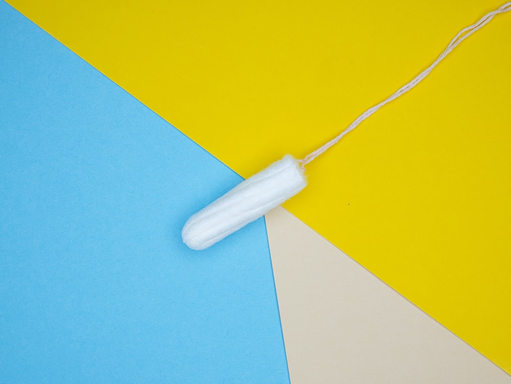 a white object on a yellow and blue background