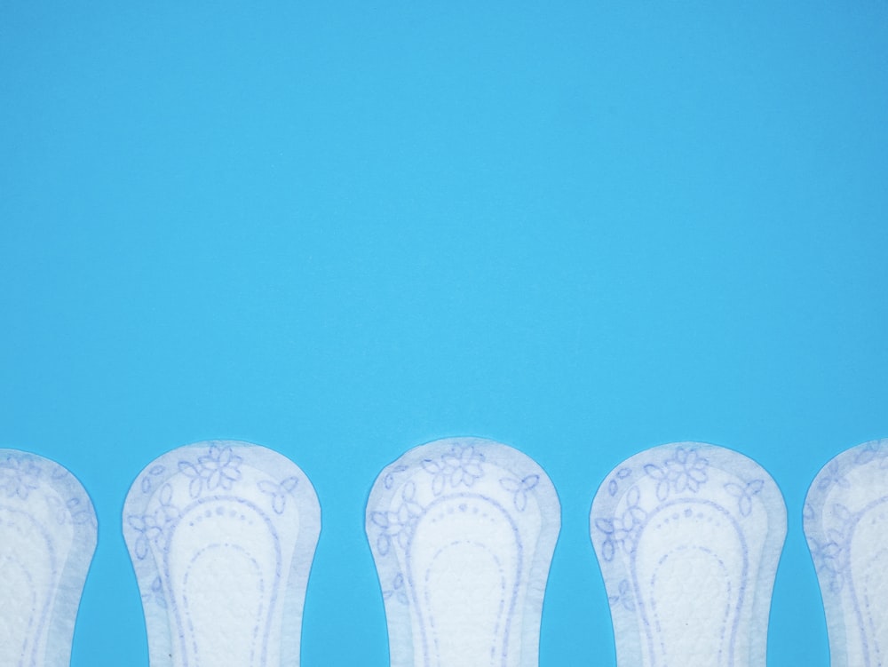 a row of white vases sitting next to each other