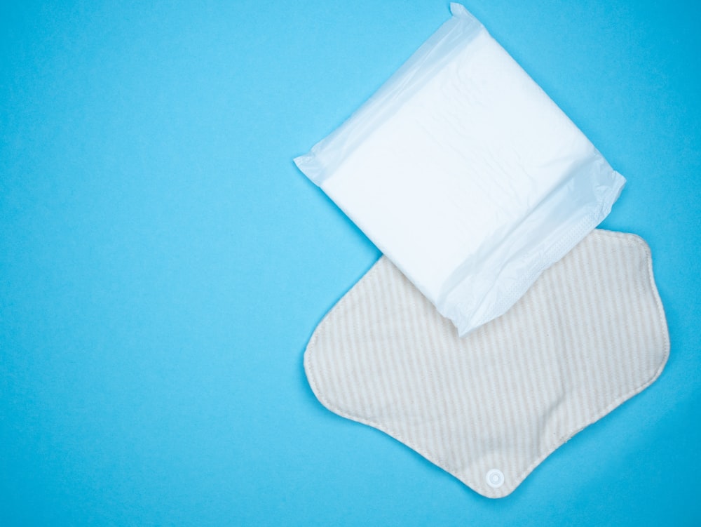 a pair of diapers sitting on top of a blue surface