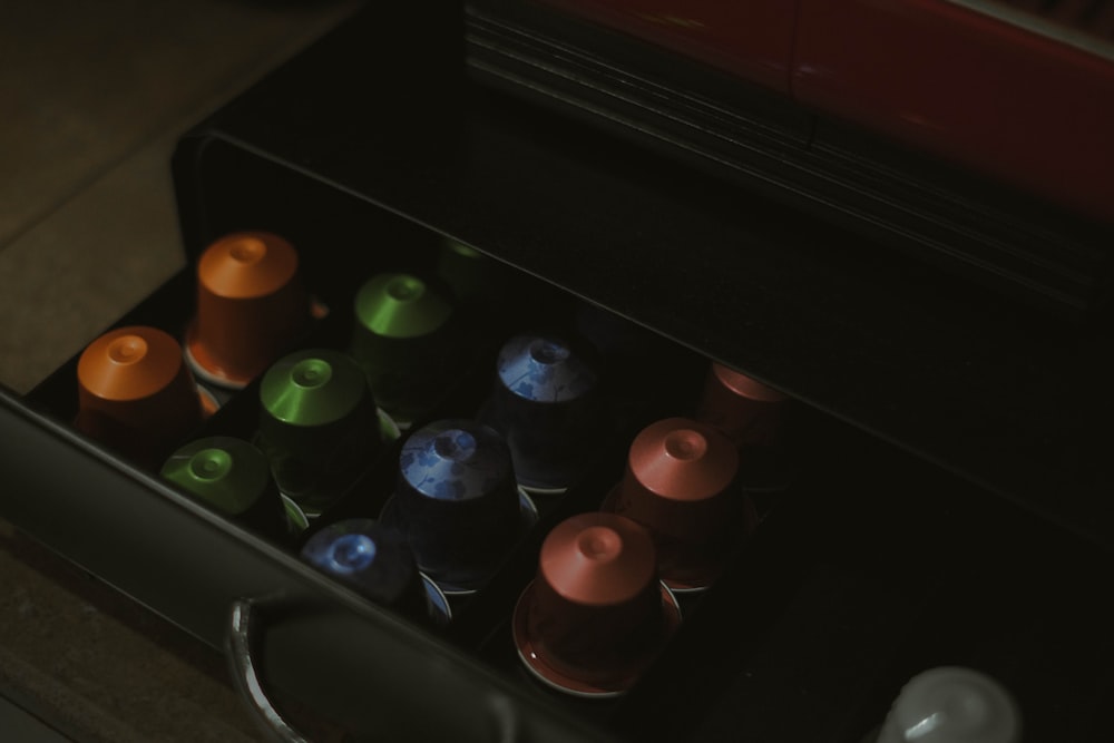 a drawer filled with lots of different colored bottles