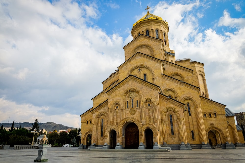 a large church with a golden roof and steeple