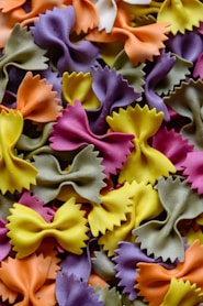 a close up of a bunch of different colored pasta