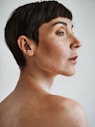Ai generated portrait of model with short dark hair and bare shoulders