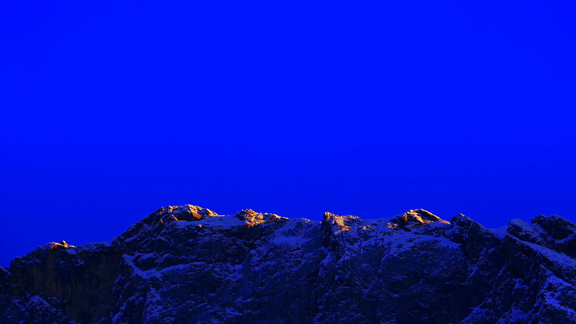 a plane flying over a mountain covered in snow