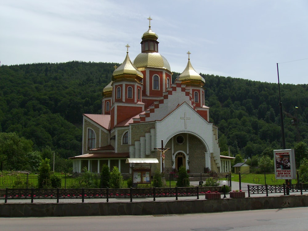 a church in a rural area with mountains in the background
