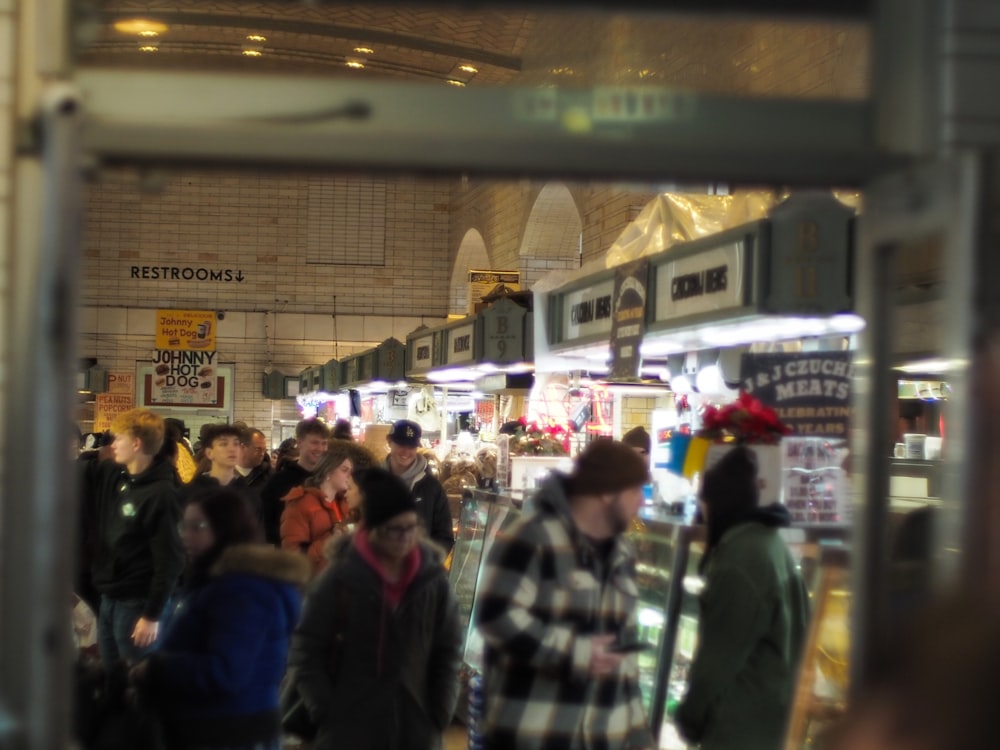 a crowd of people walking around a store