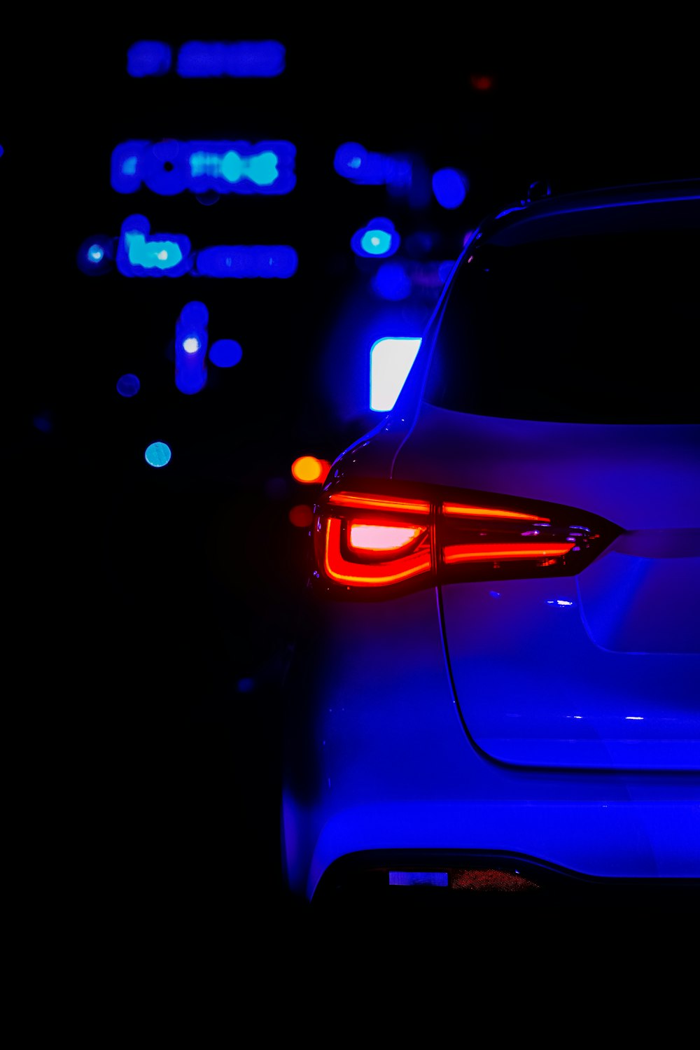 the tail lights of a car in the dark