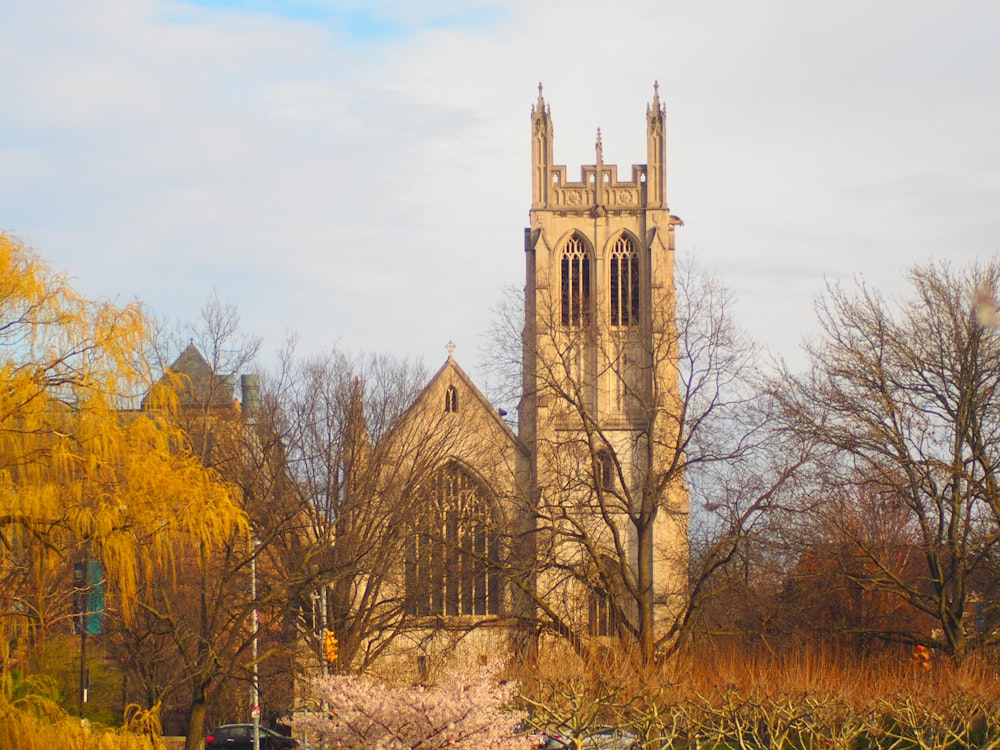 a church with a tall tower surrounded by trees