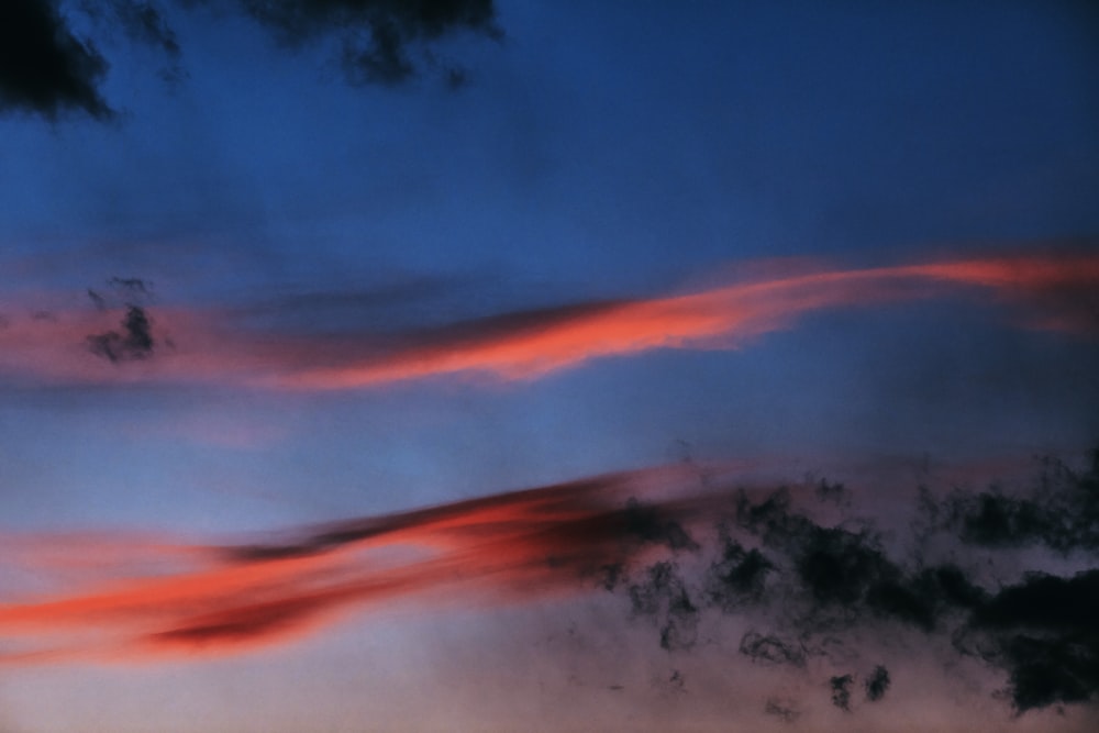 a red and blue sky with some clouds