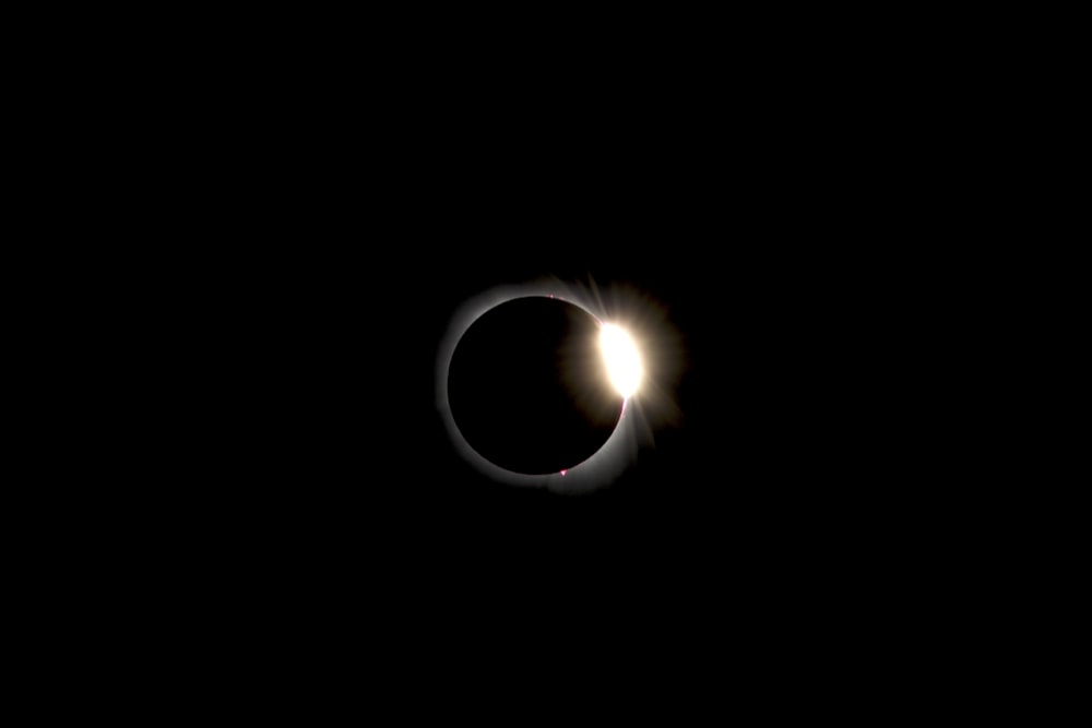 a solar eclipse is seen in the dark sky