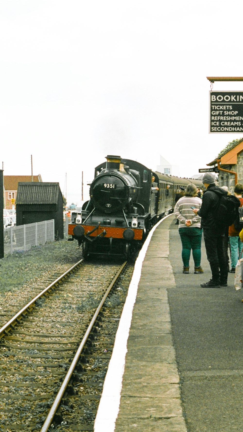 a train pulling into a train station next to a platform