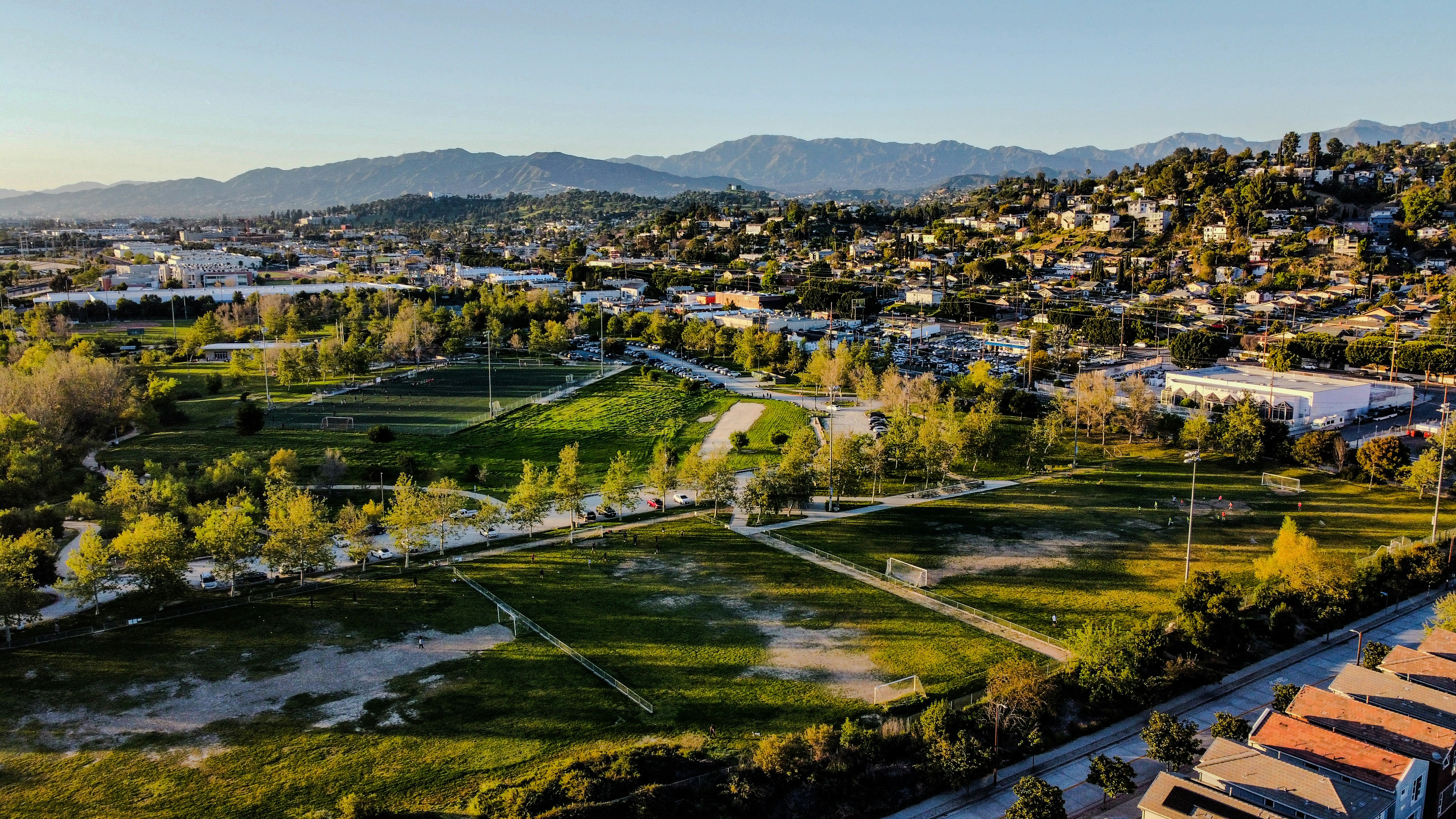 an aerial view of a city with mountains in the background