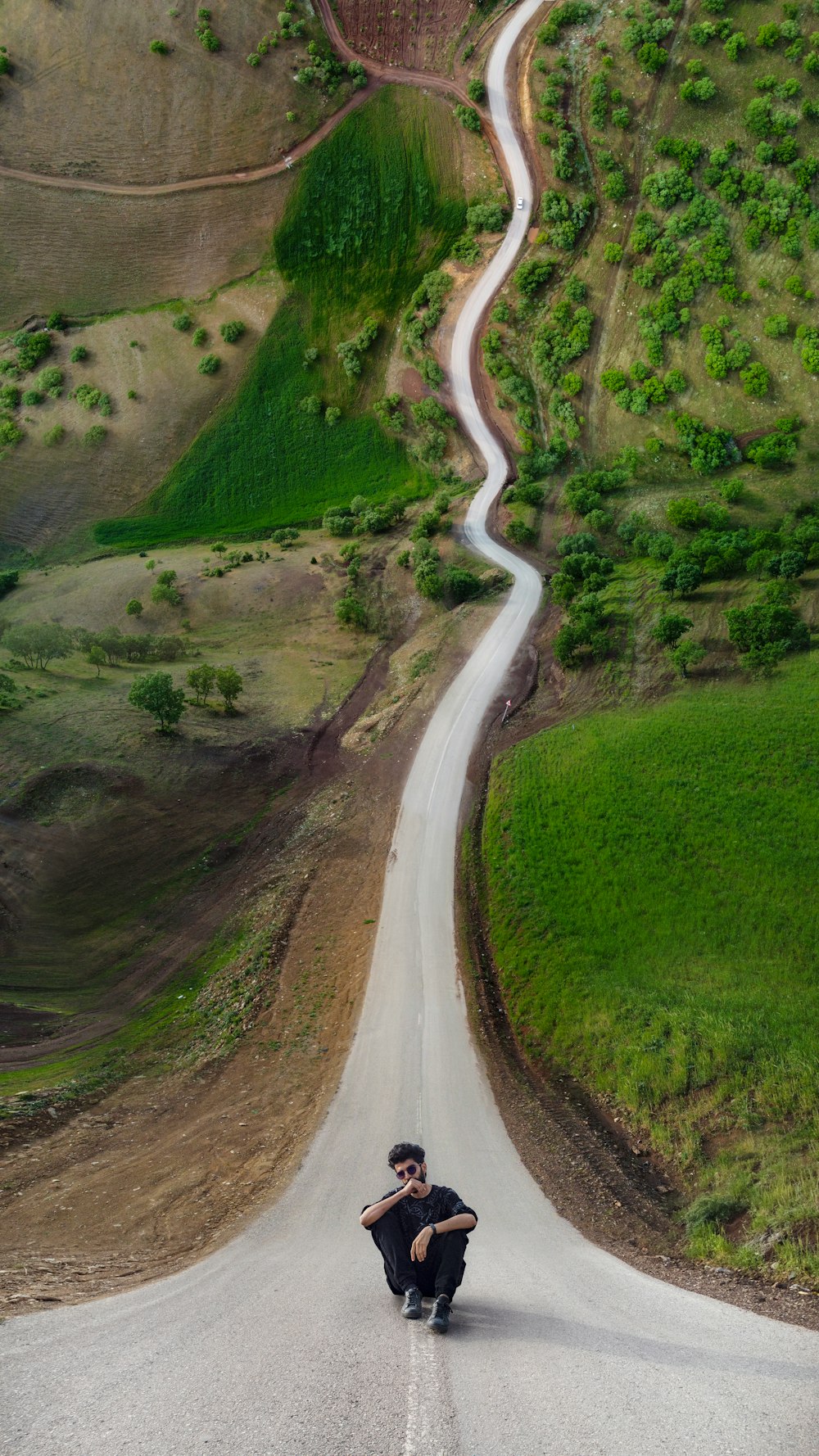 a man riding a skateboard down a curvy road