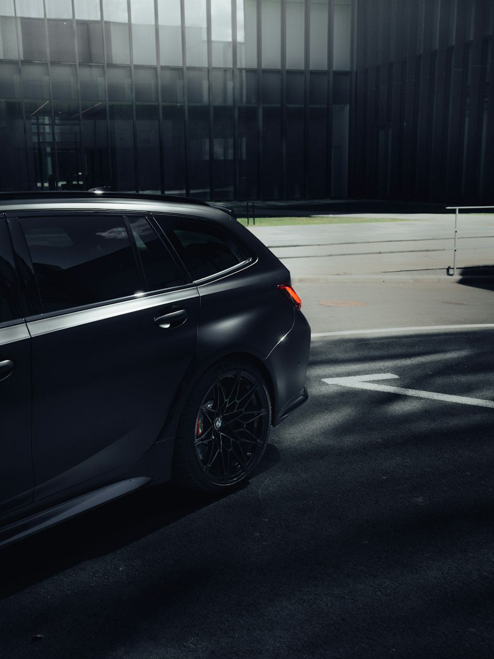 a black car parked in a parking lot