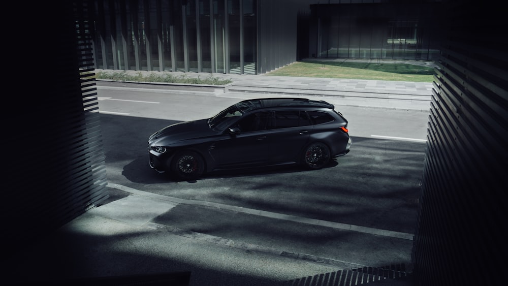 a black car parked in a parking lot at night