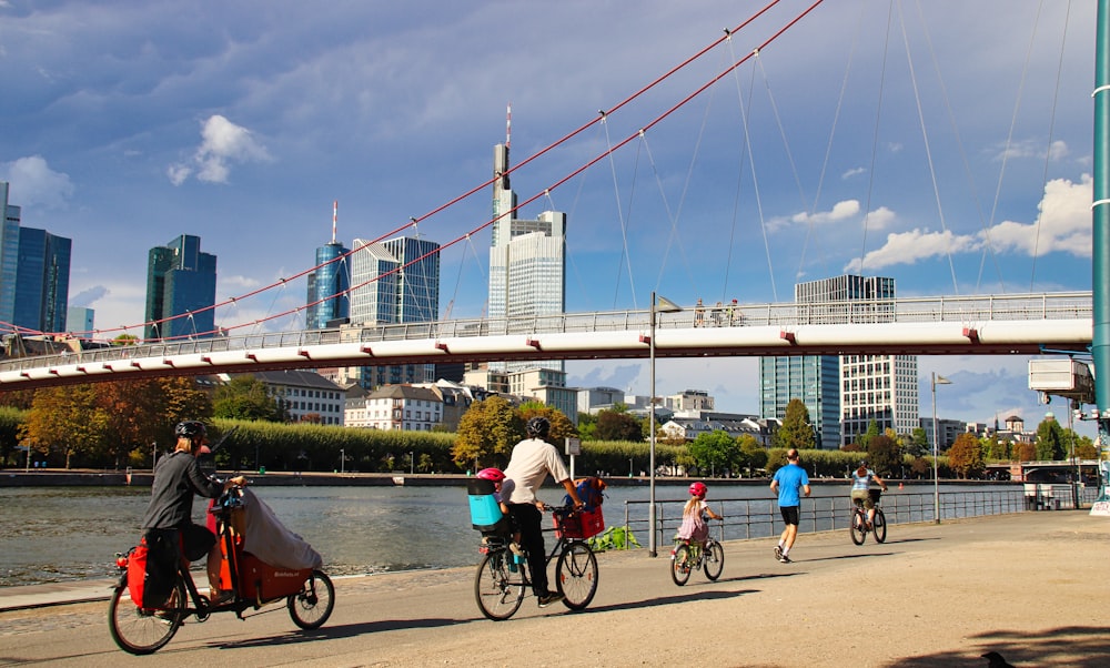 a group of people riding bikes across a bridge