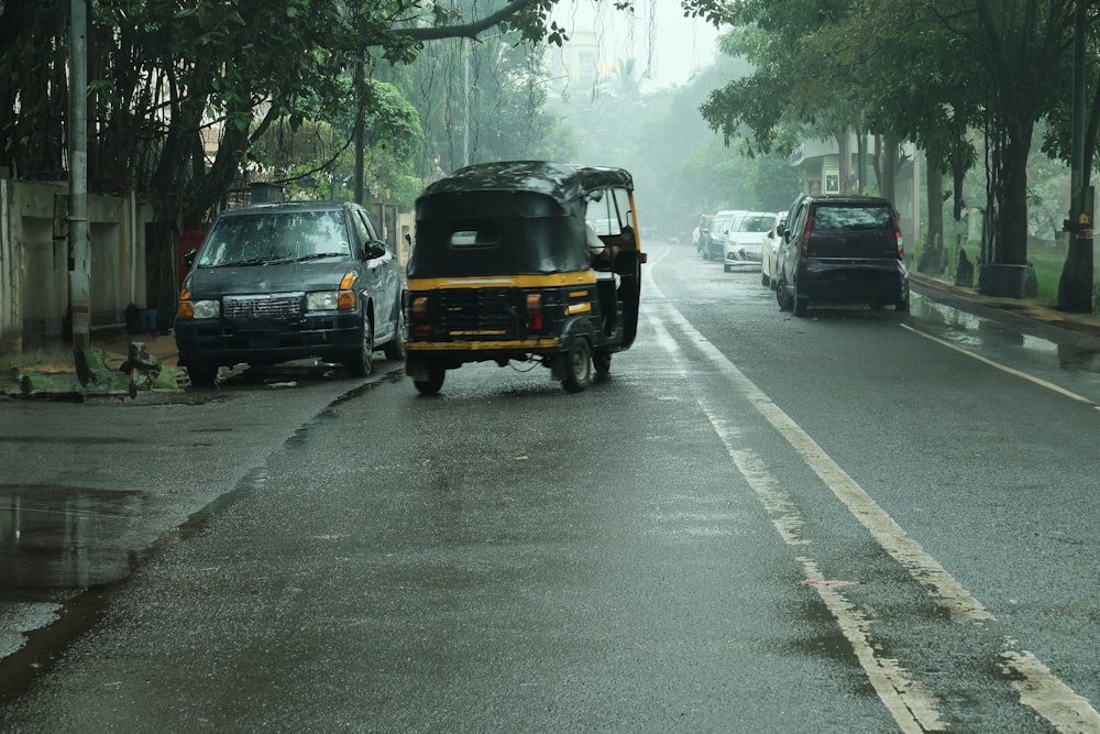 a car driving down a rain soaked street